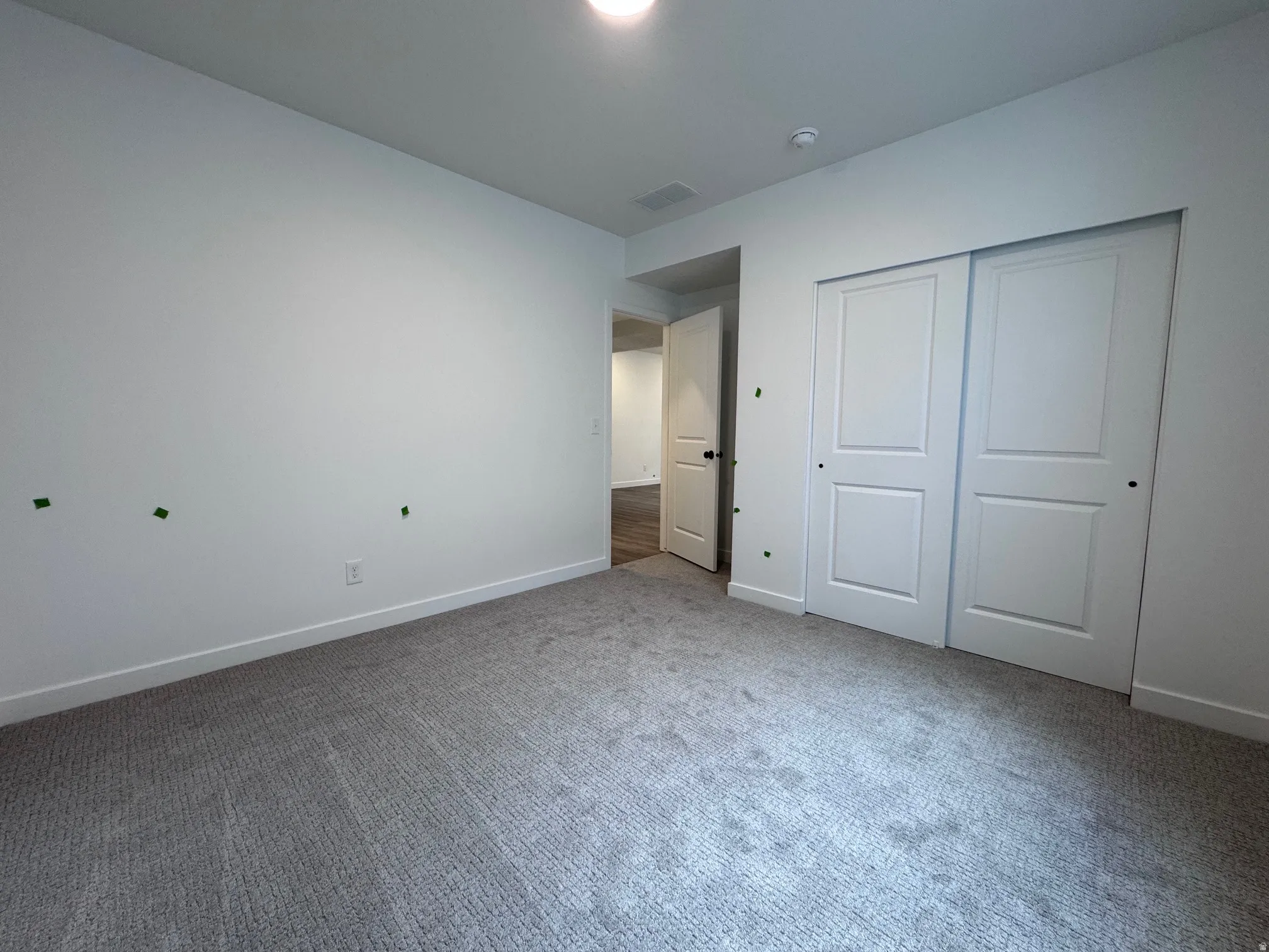 Neutral-toned wall-to-wall carpeting complements bright white walls