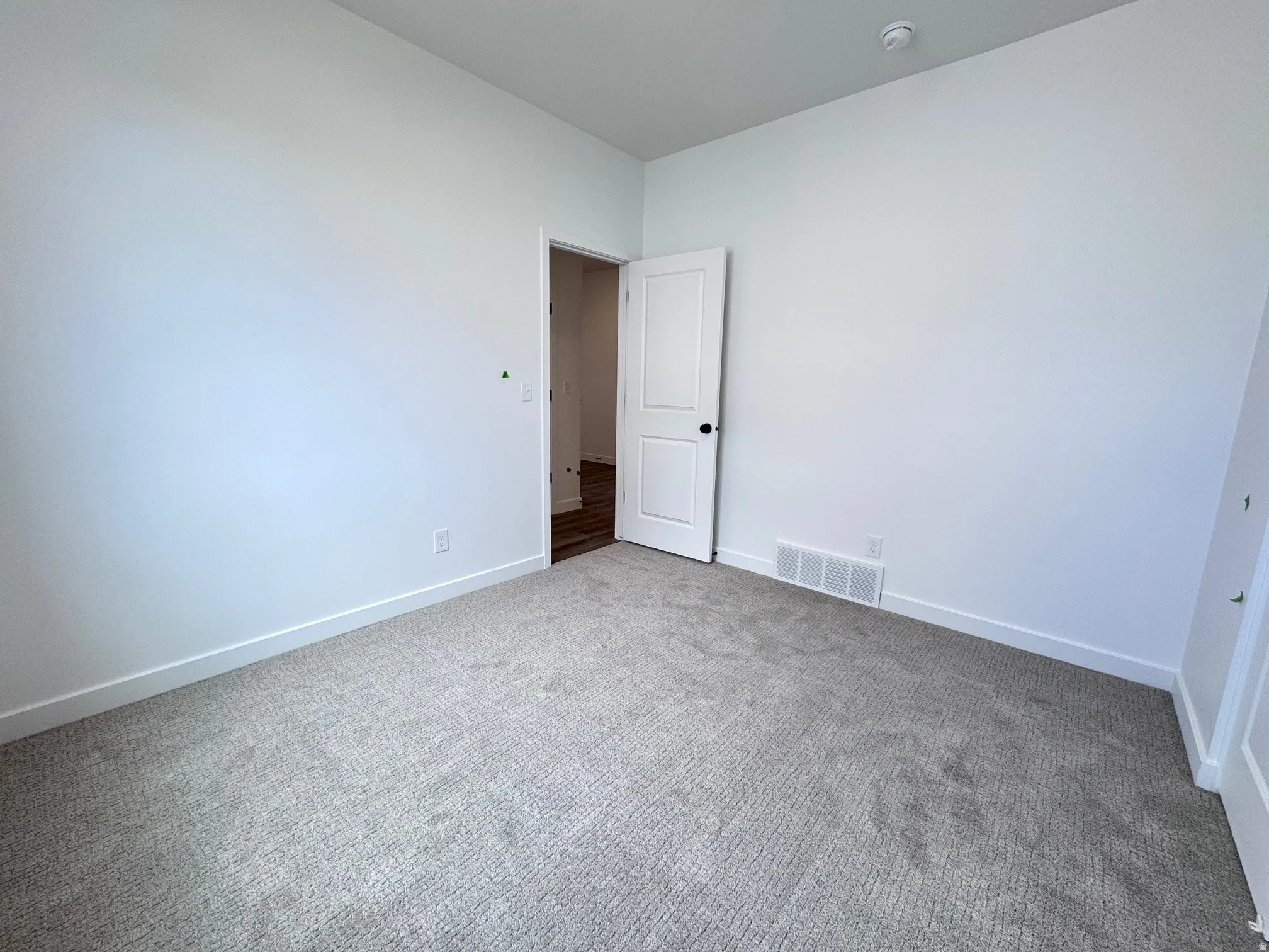 Room featuring light gray carpeting, white walls, and white baseboards