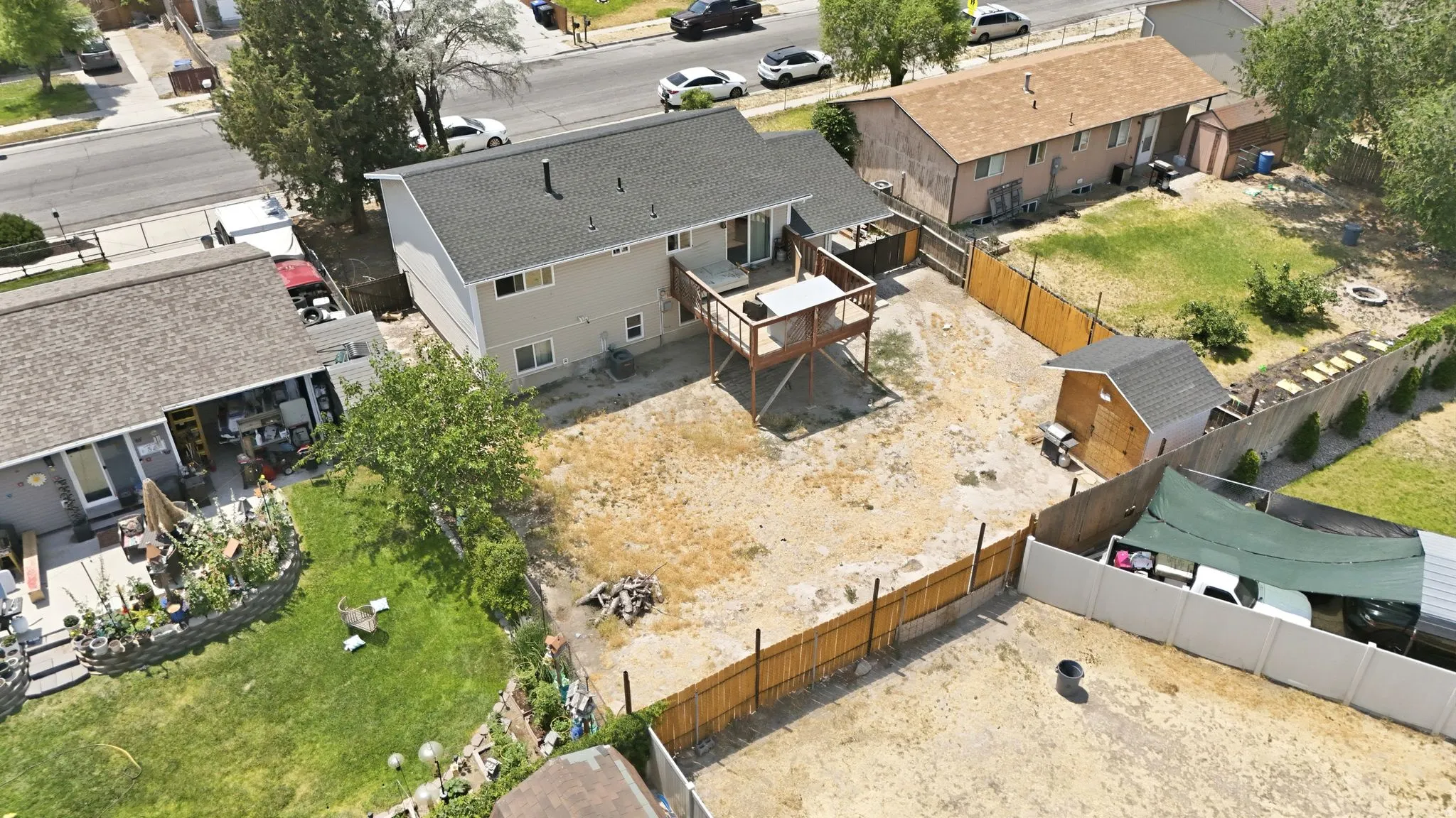 Two-story residence featuring a gray exterior and a dark shingle roof