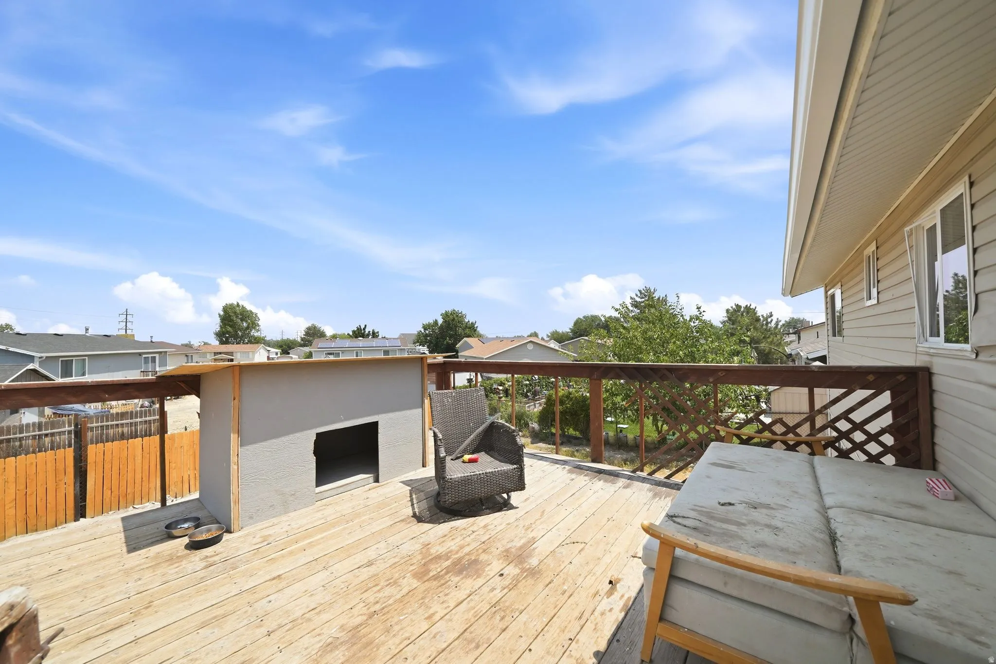 Expansive wood deck with a perimeter railing and lattice detailing