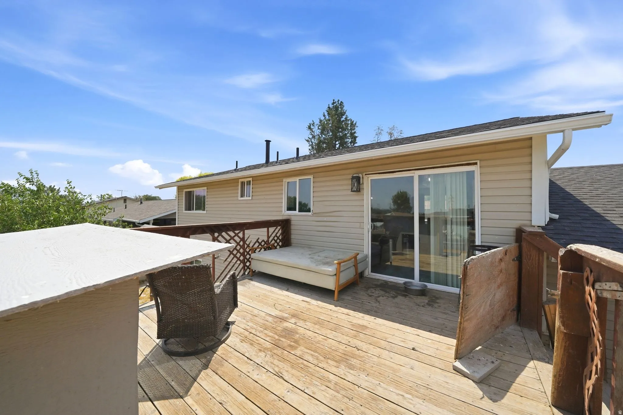 Wood deck featuring a perimeter railing and tan siding exterior