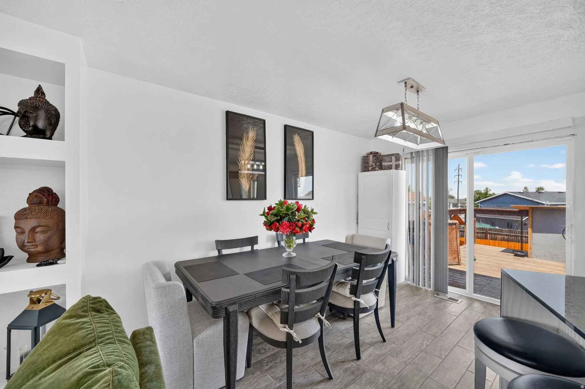 Dining area featuring wood-finish flooring and a white color palette