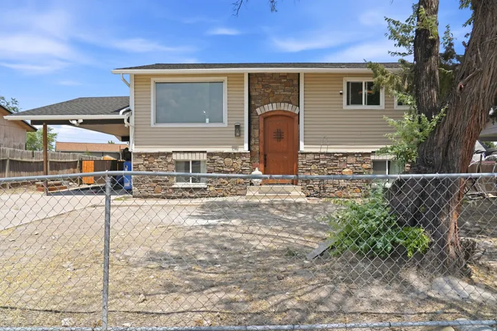 Split-level residence featuring stone and siding exterior
