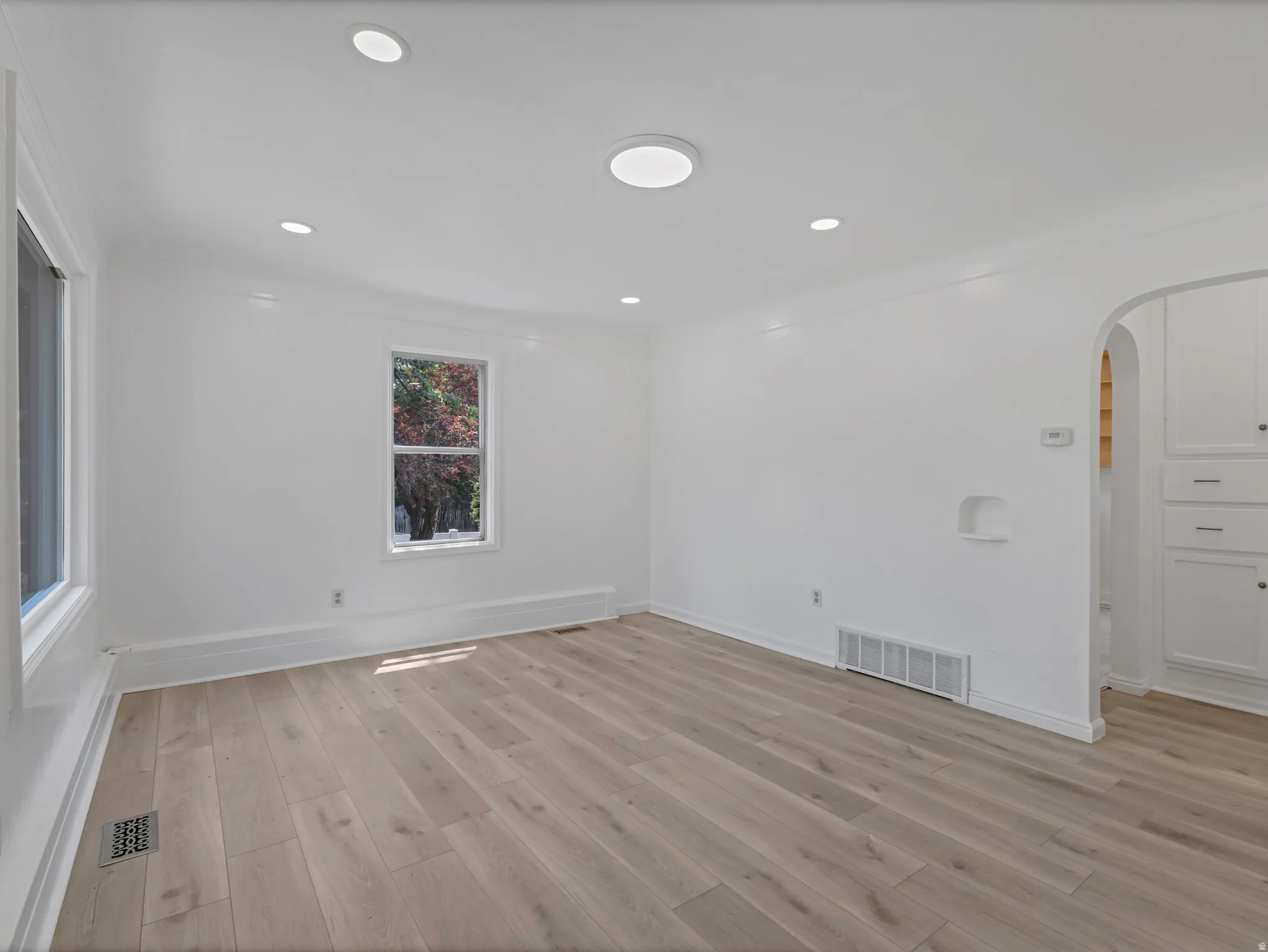 Spacious interior with neutral wall tones and light wood-finish flooring