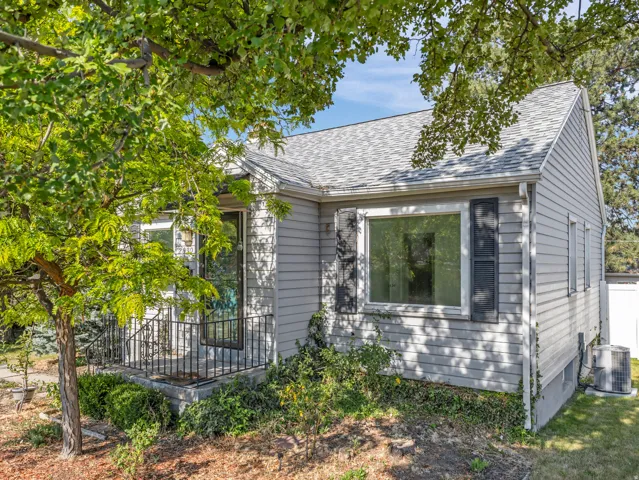 Light gray siding exterior with a dark gray shingle roof