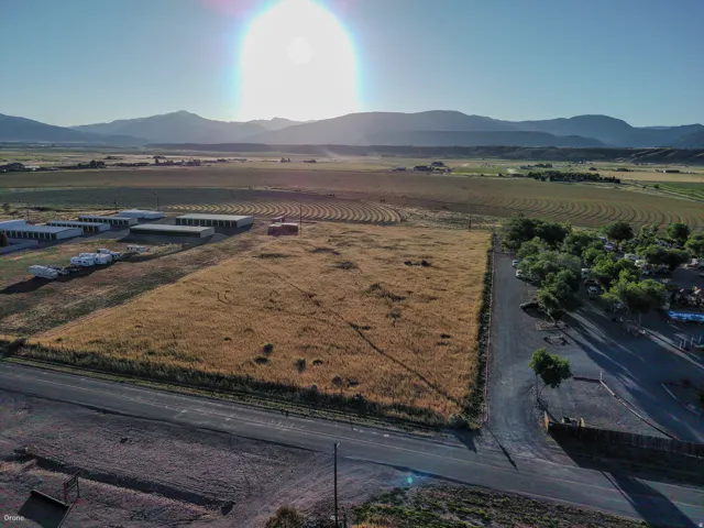Expansive land parcel with surrounding agricultural fields and distant mountain ranges