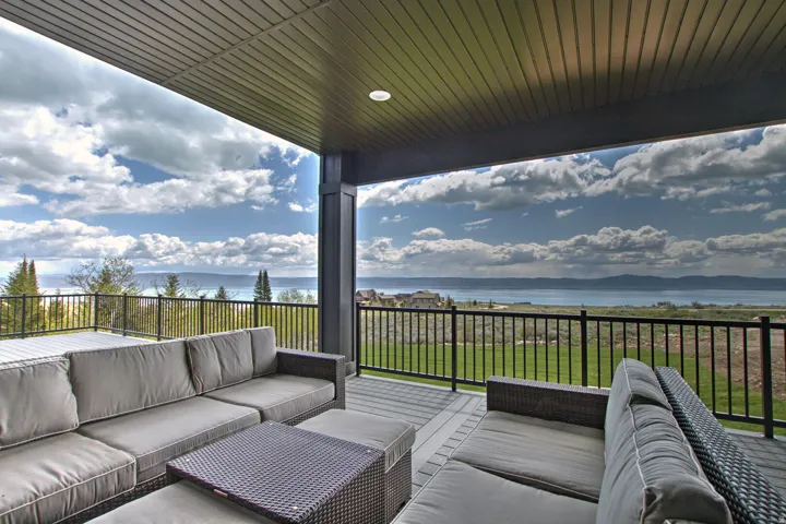 Expansive covered patio with recessed lighting and composite decking