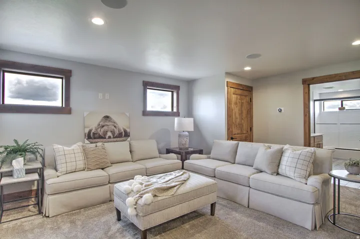 Spacious living area featuring neutral-toned walls, recessed lighting, and integrated ceiling speakers