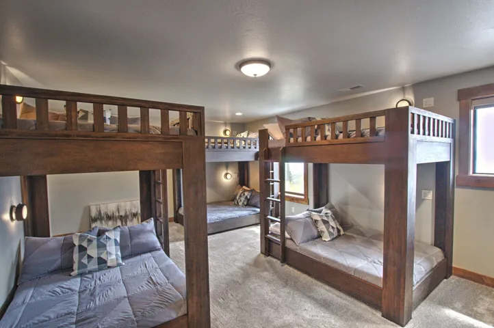 Room featuring multiple built-in bunk beds with dark wood frames