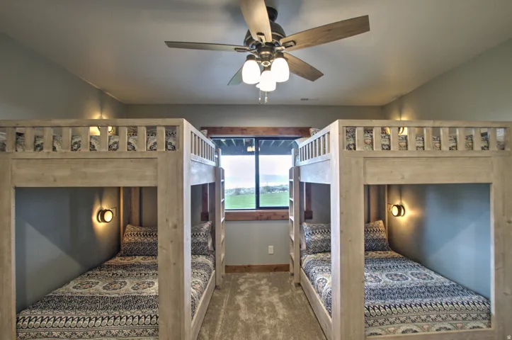 Room featuring two built-in bunk bed structures with integrated wall sconces