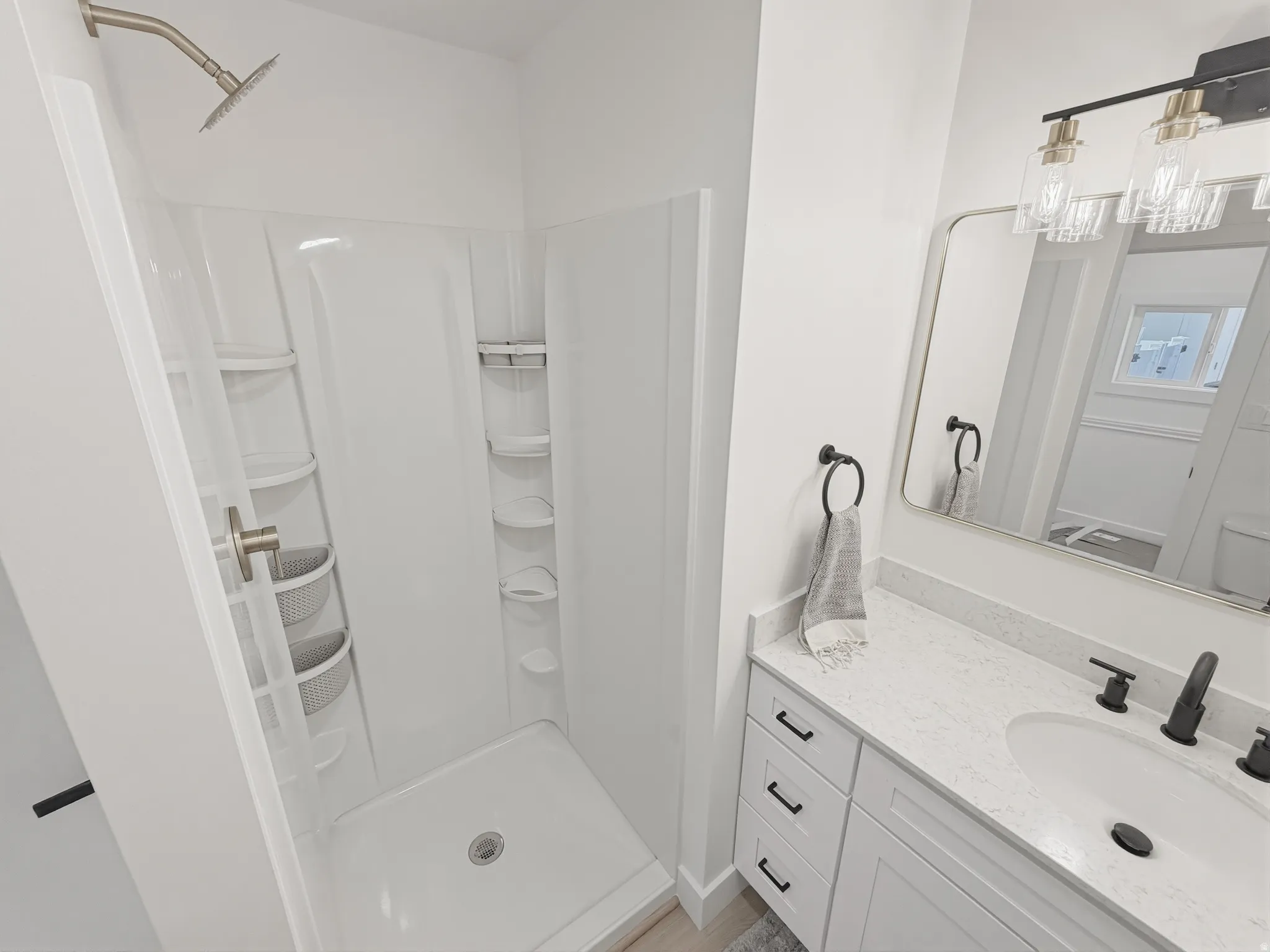 Contemporary bathroom featuring a white shower stall with a brushed nickel shower head