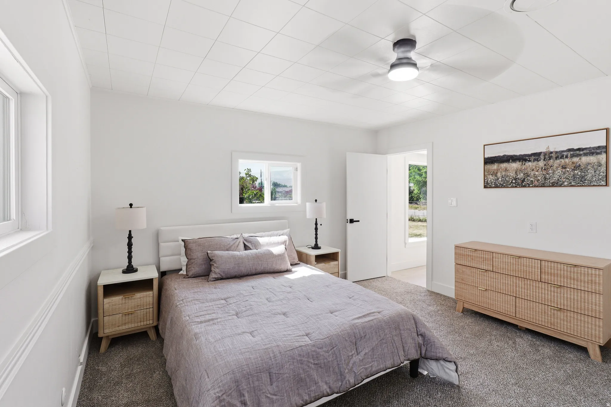 Bedroom featuring plush carpet, white walls, and a textured ceiling