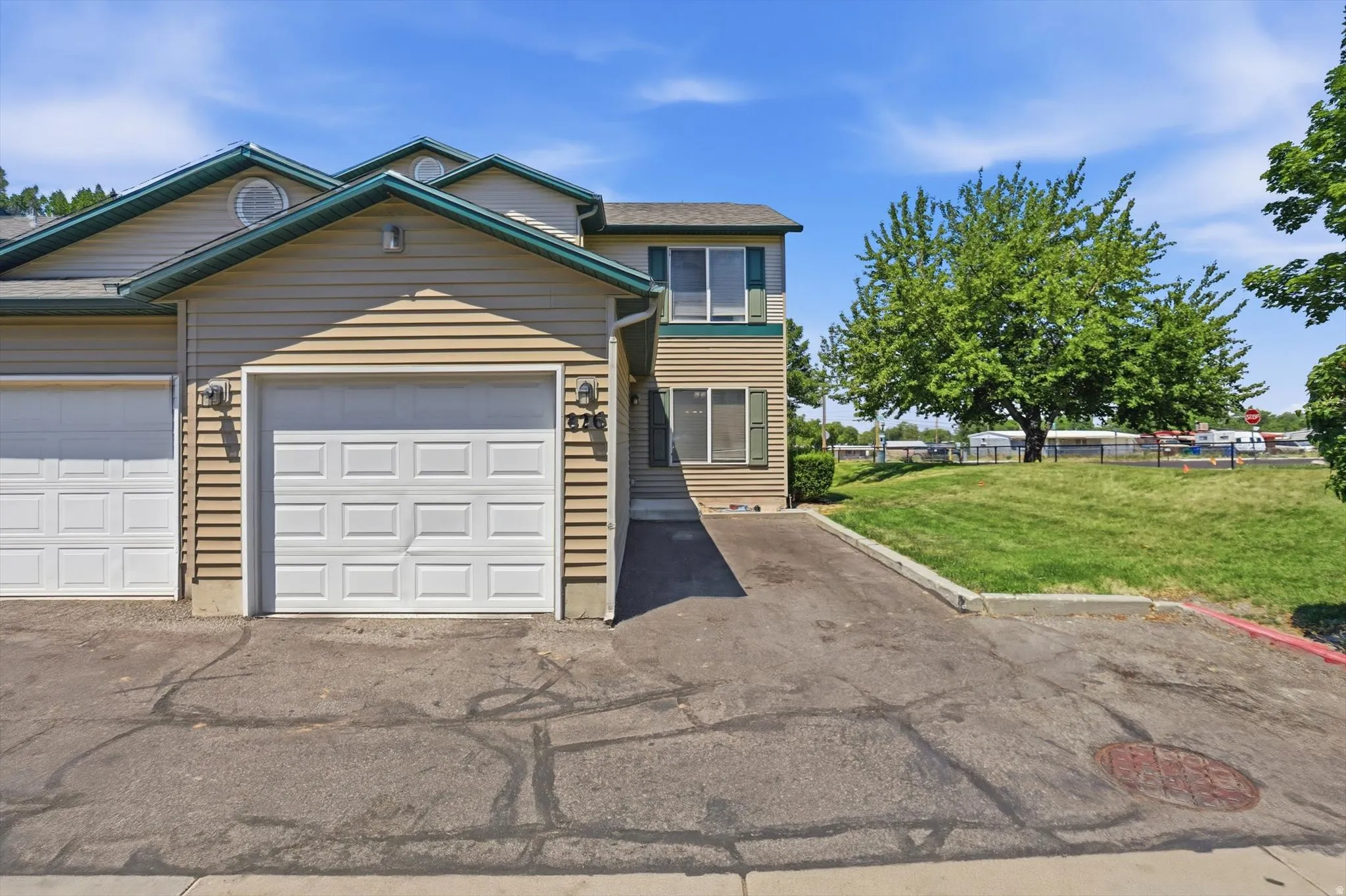 Two-story townhouse exterior with horizontal siding and a single-car garage