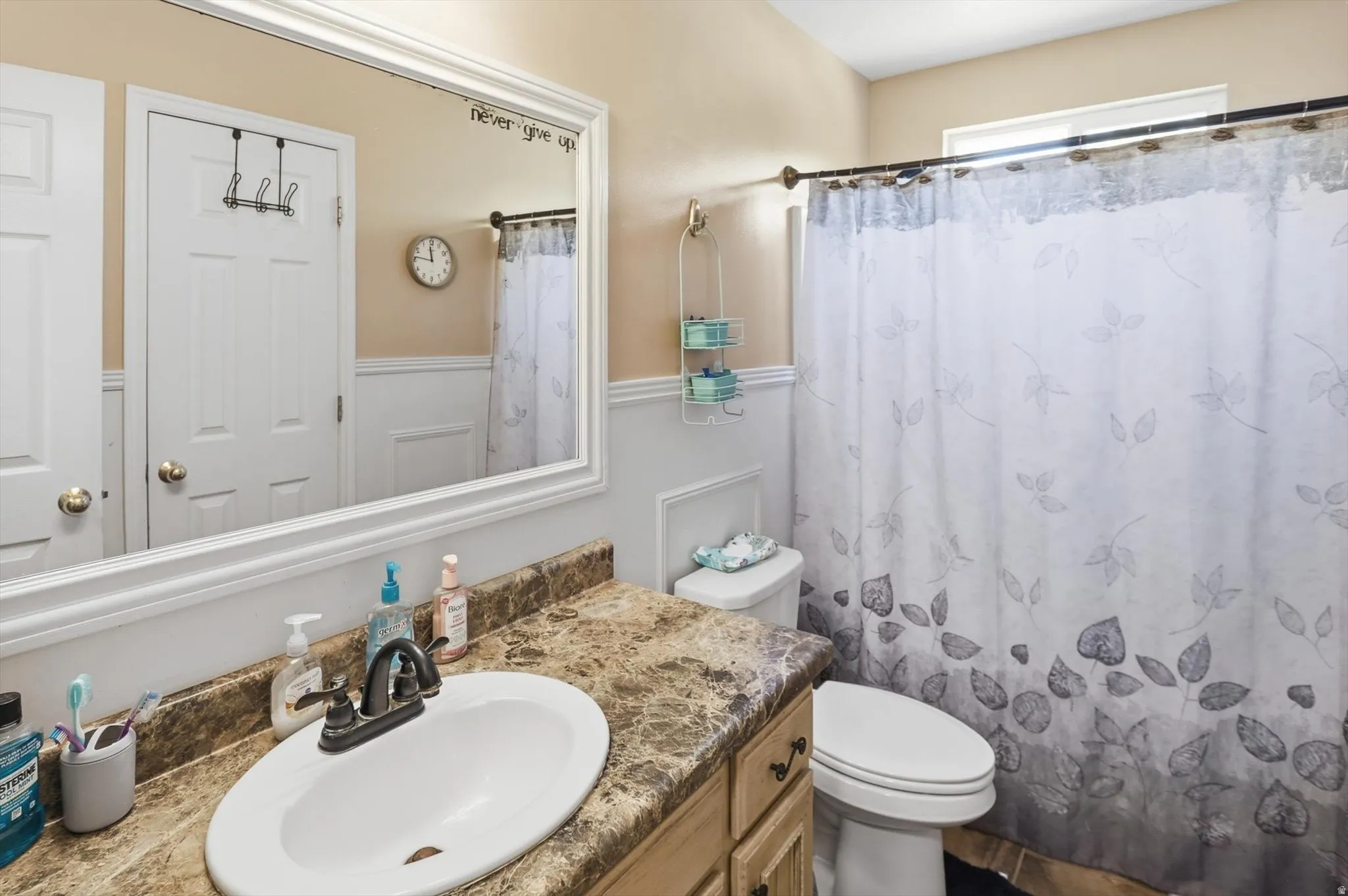 Bathroom vanity with an integrated sink, bronze-finish faucet, and a patterned countertop