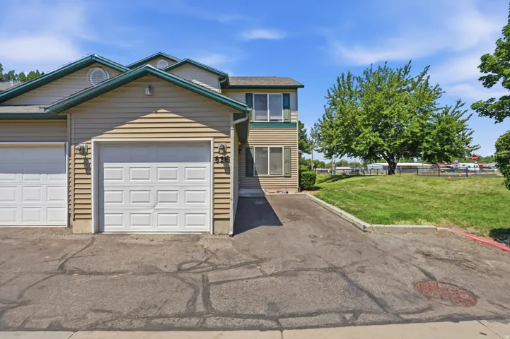 Two-story townhouse exterior with horizontal siding and a single-car garage