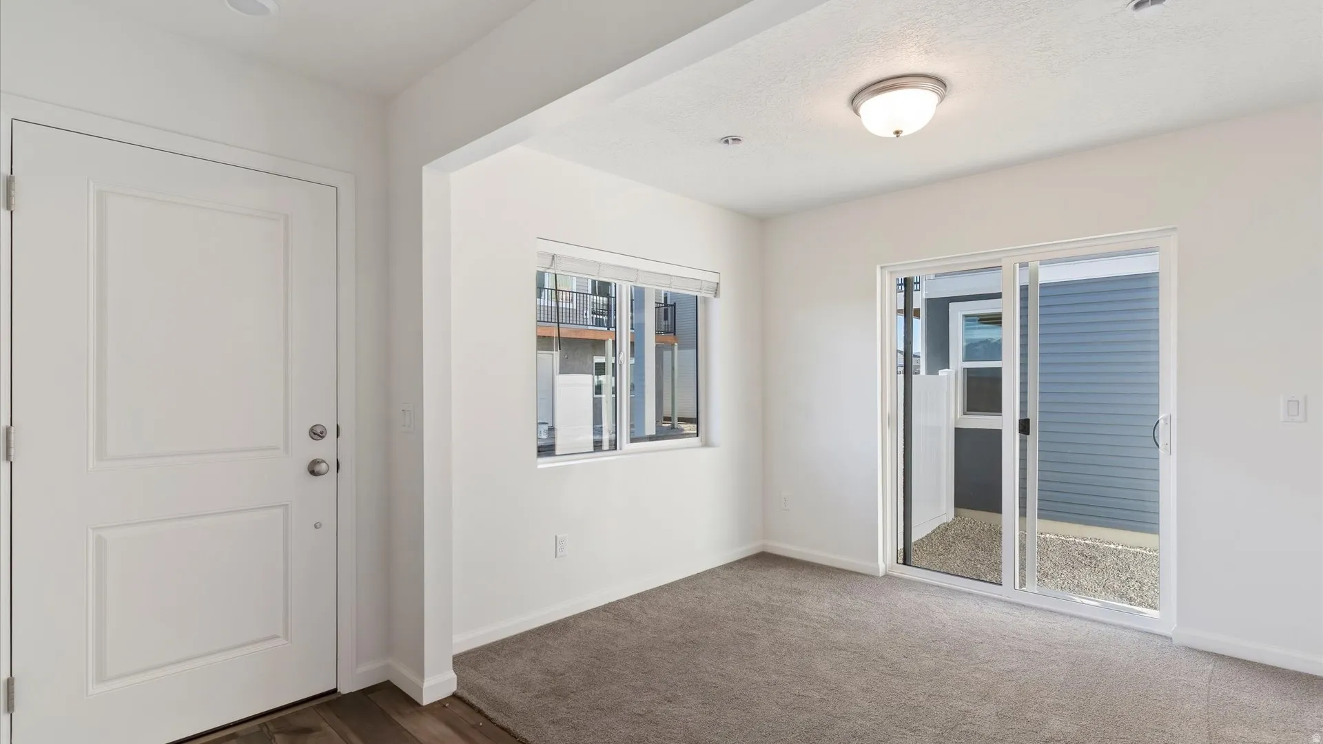 Entryway featuring a paneled door with brushed nickel hardware, wood-finish flooring, and a recessed ceiling light
