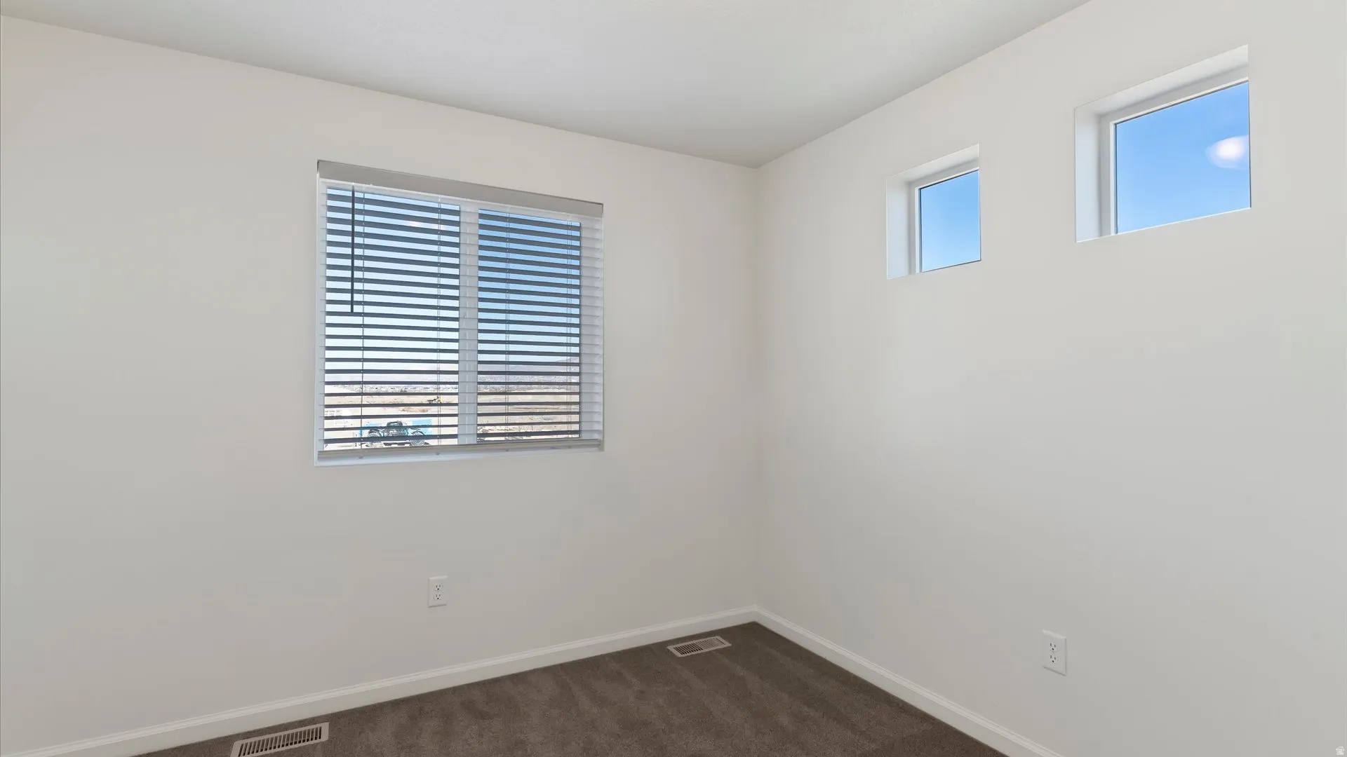 Neutral wall paint and brown carpeting define this interior space