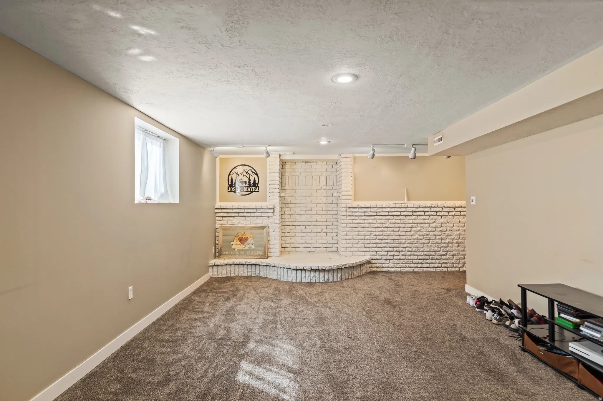 Spacious room featuring neutral carpeting and painted walls