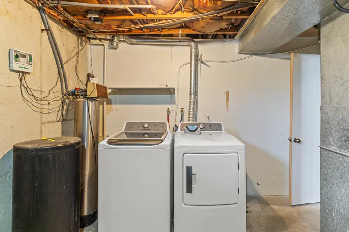 Dedicated utility area with concrete flooring