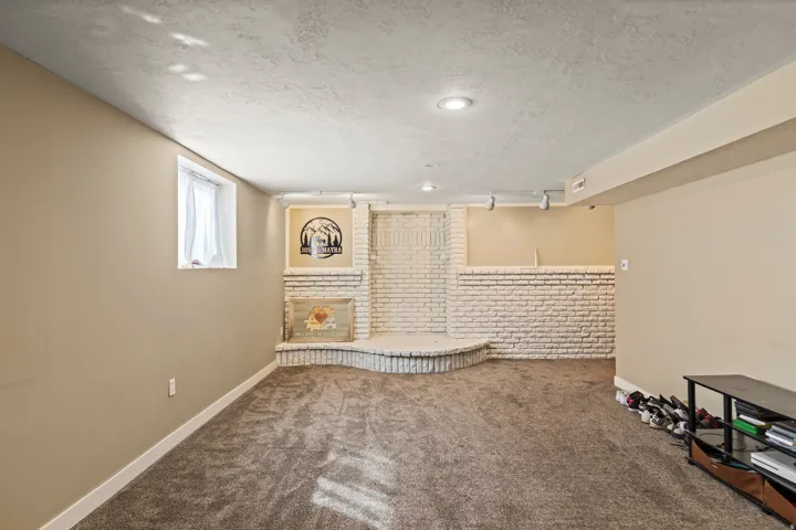 Spacious room featuring neutral carpeting and painted walls