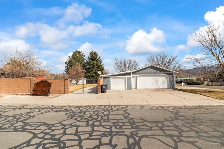 Spacious garage structure with two overhead doors and an additional service door