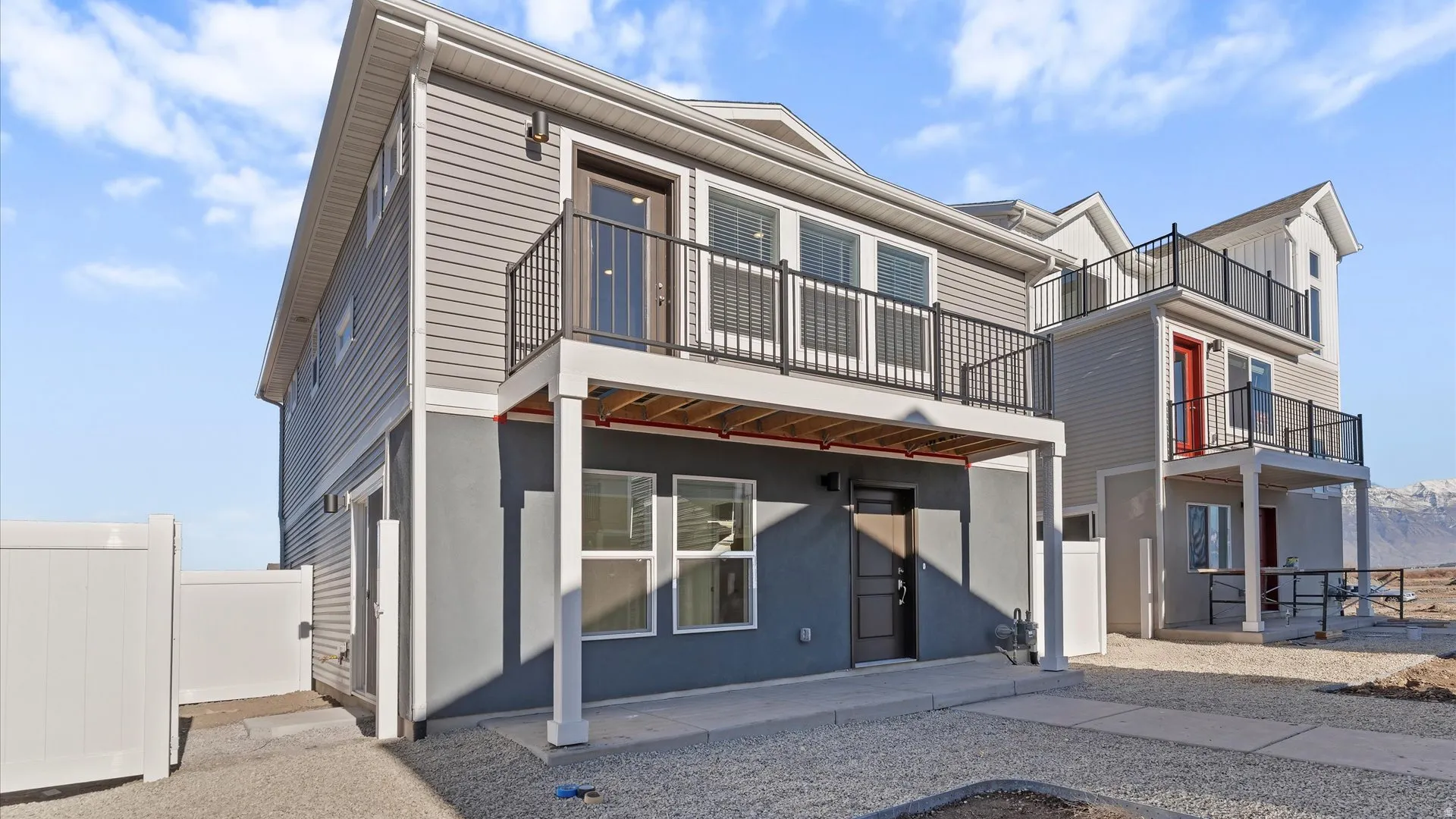 Modern multi-story exterior with horizontal siding and a lower-level painted facade