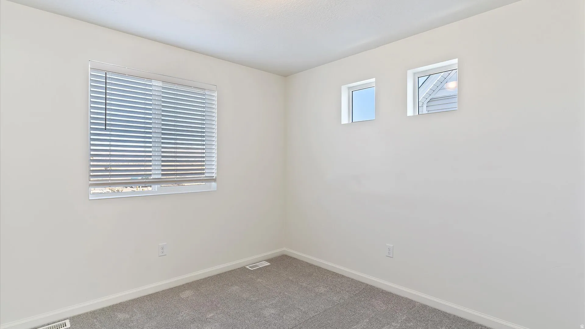 Neutral tone wall paint with a textured ceiling finish
