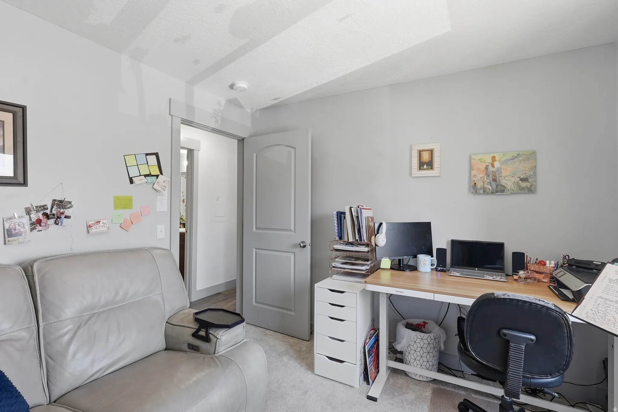 Neutral-toned interior room featuring light-colored walls and carpeted flooring