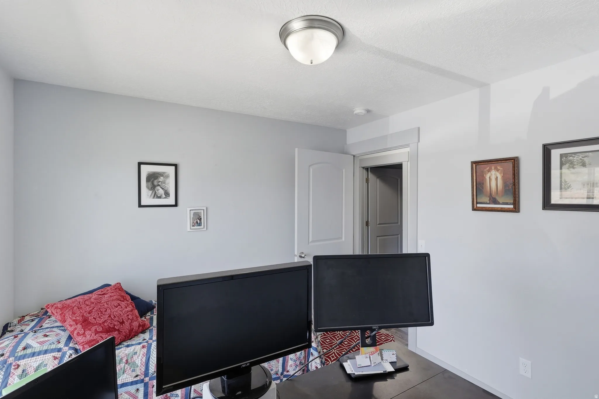 Interior room featuring light-toned walls, a white ceiling, and an interior door with trim