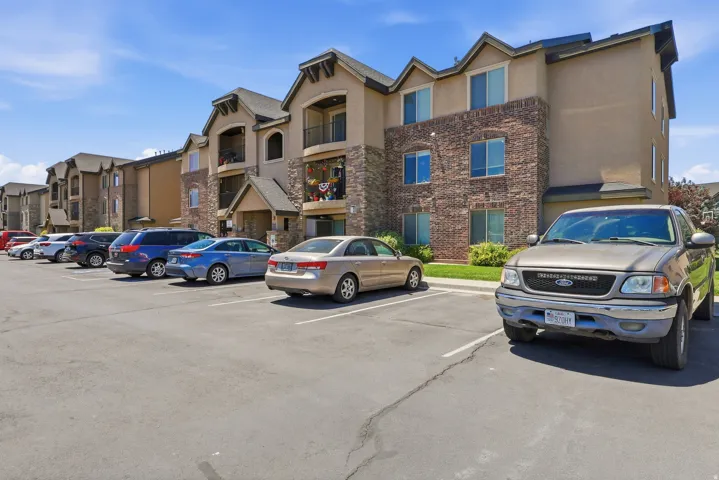 Multi-story residential building featuring a stone and stucco exterior