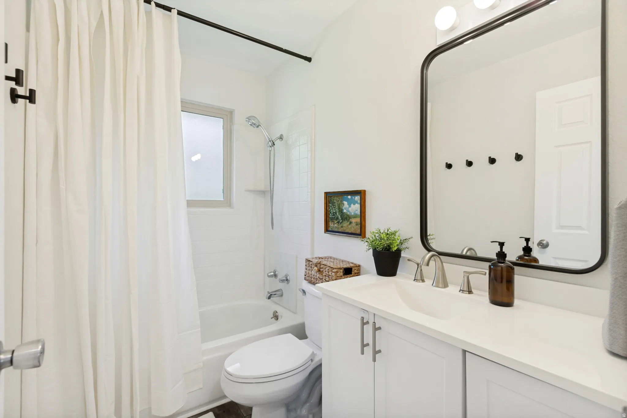 Vanity with integrated sink, white countertop, and brushed nickel faucet set