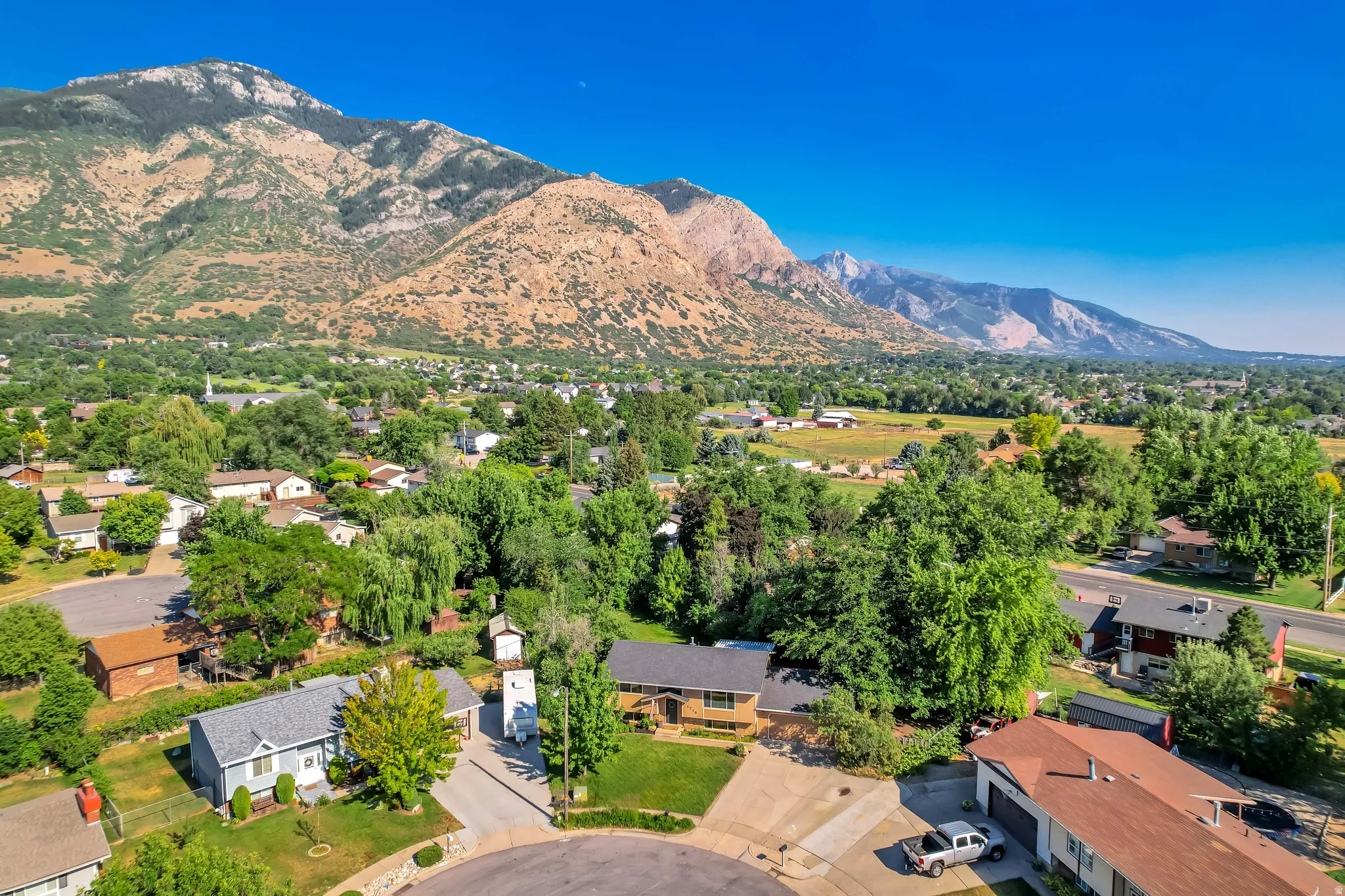 Aerial perspective showcasing a residential neighborhood with a mountain backdrop