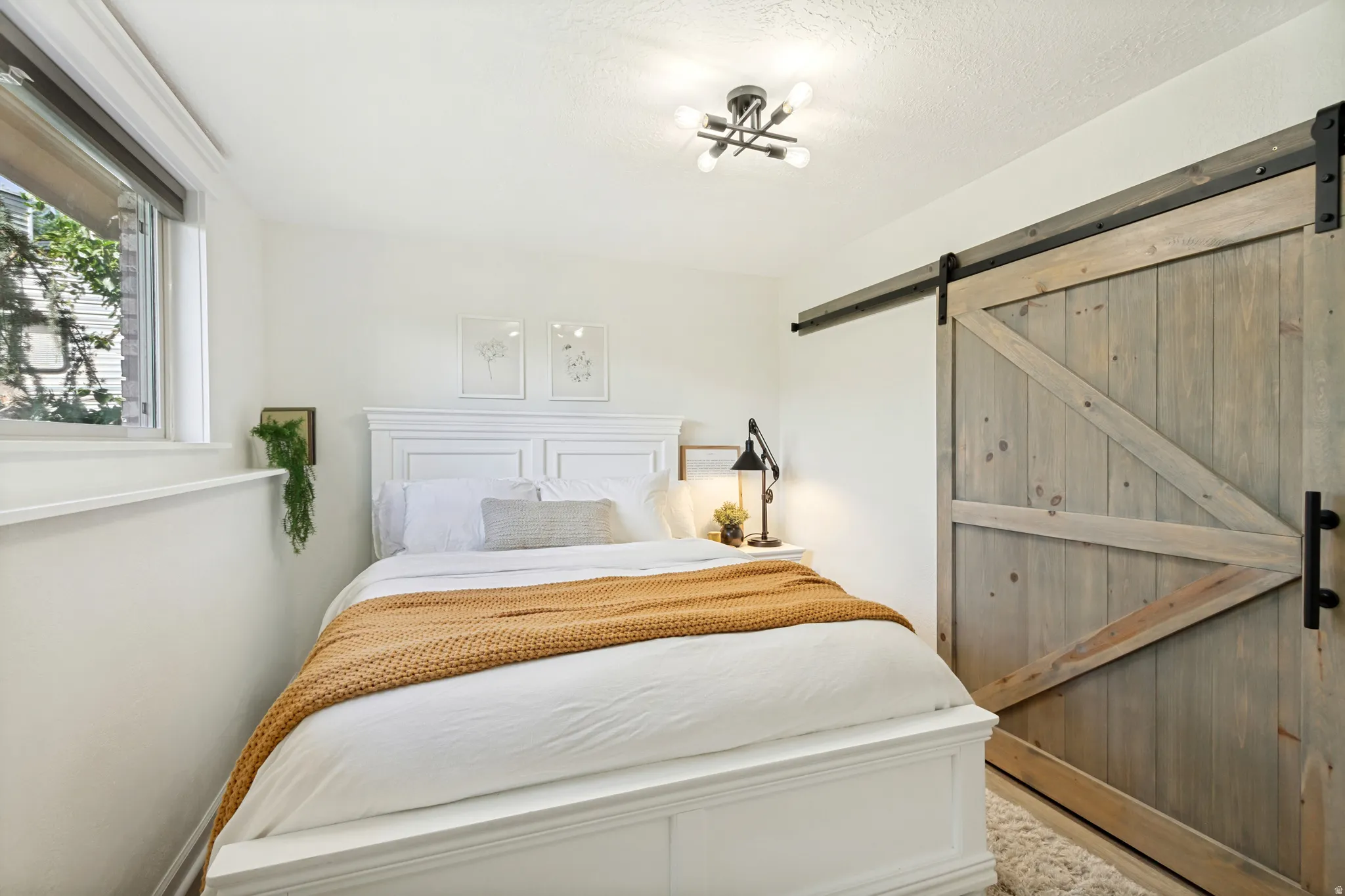 Barn door entry with a visible wood grain finish and black hardware