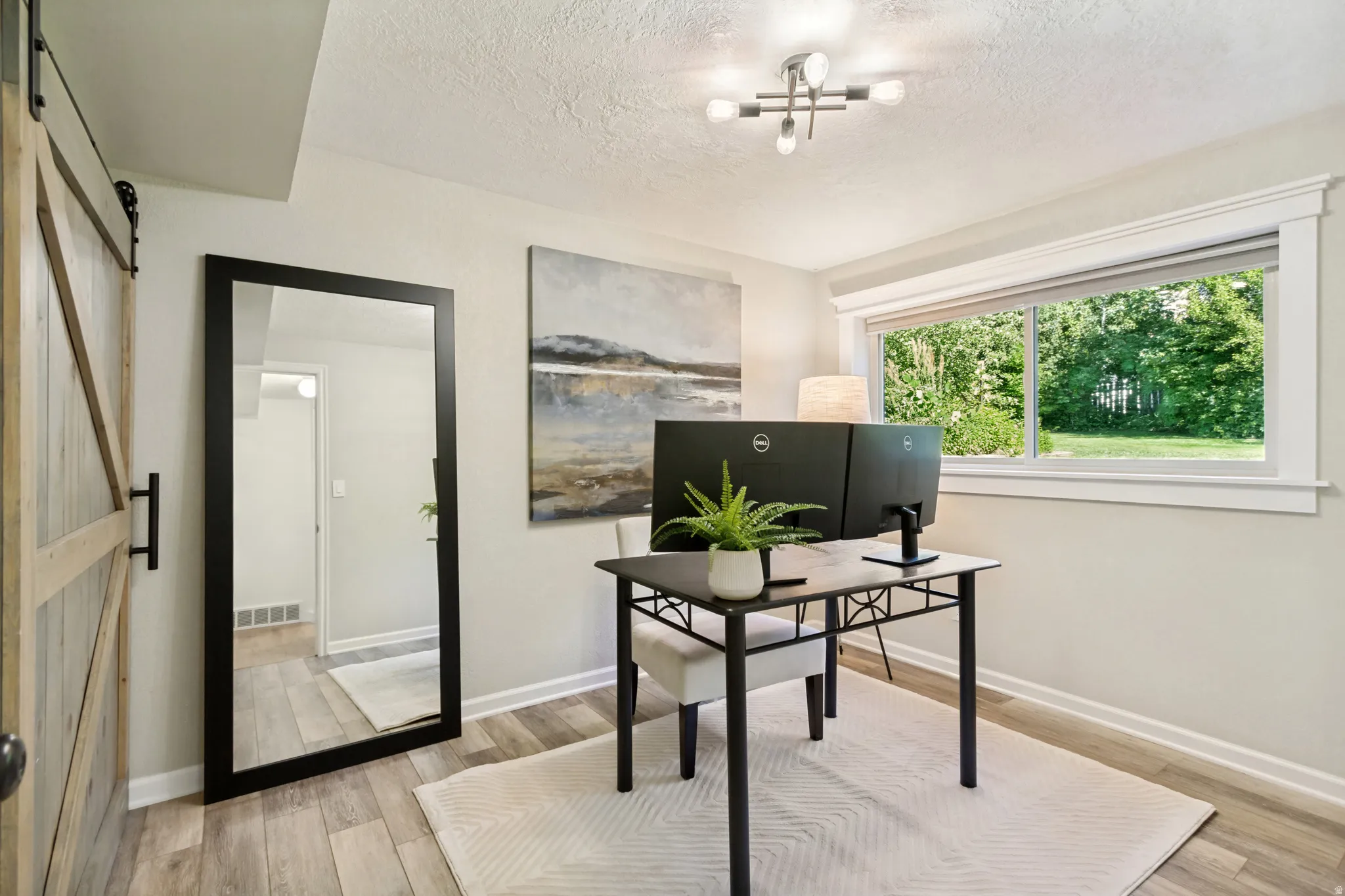 Light wood-finish flooring complements the neutral wall color