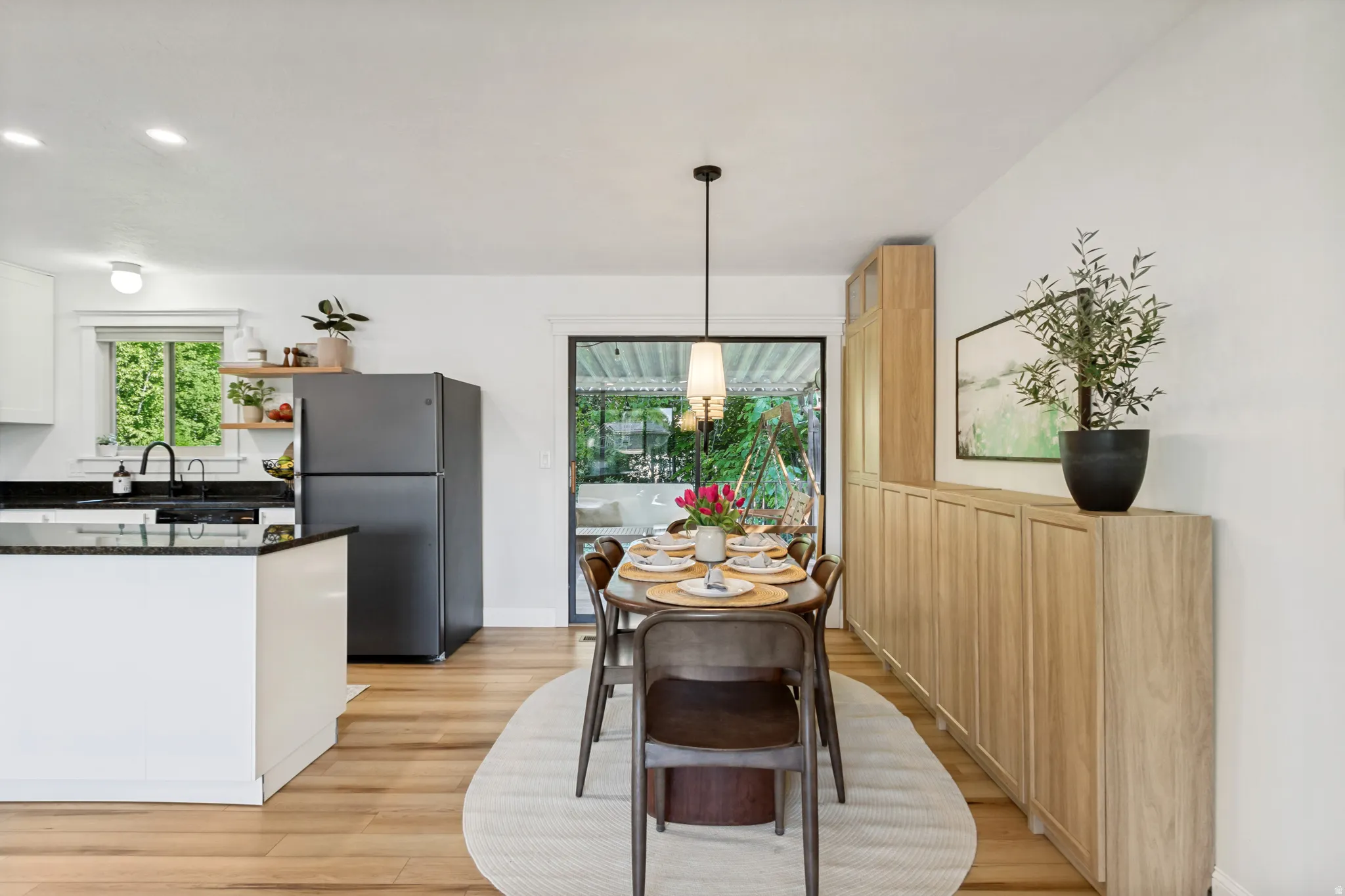 Open-concept dining area featuring wood-finish flooring