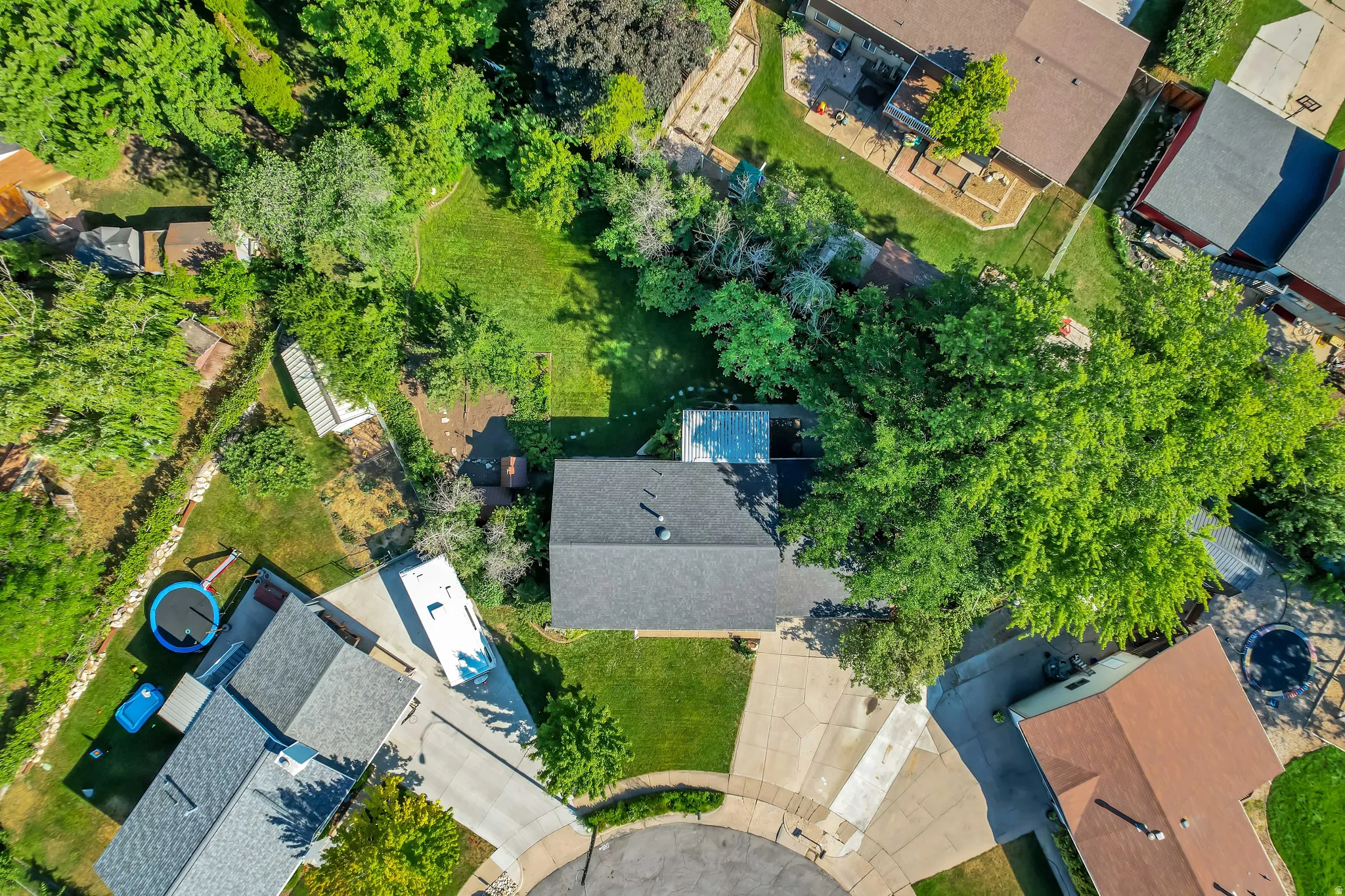 Large residential lot featuring mature trees, a cul-de-sac location, and a spacious backyard