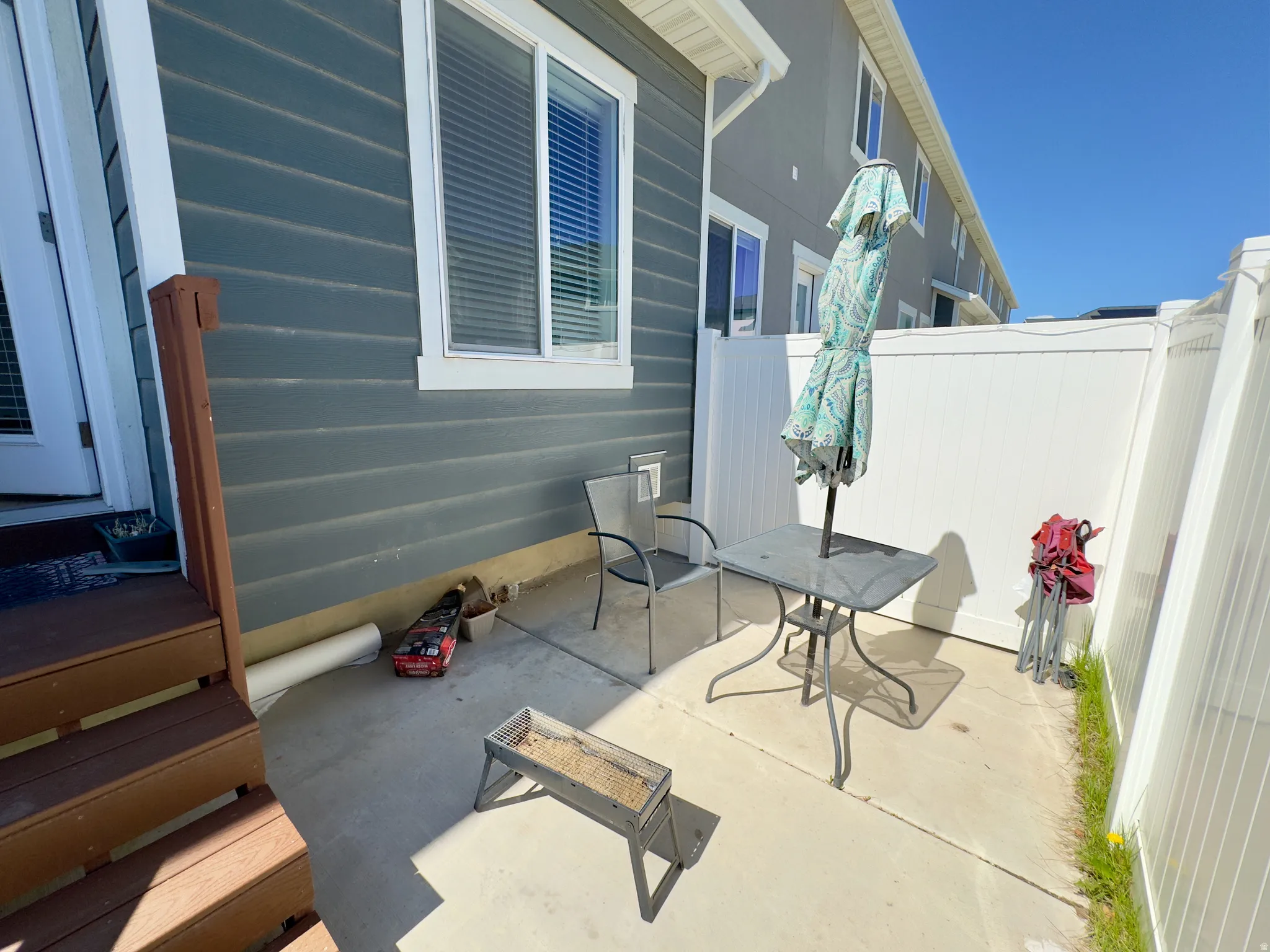 Private patio area featuring concrete flooring