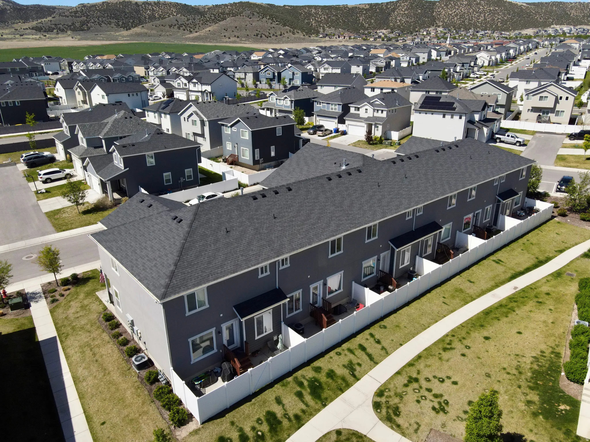 Townhome community featuring private fenced patios, individual backyards, and expansive green spaces