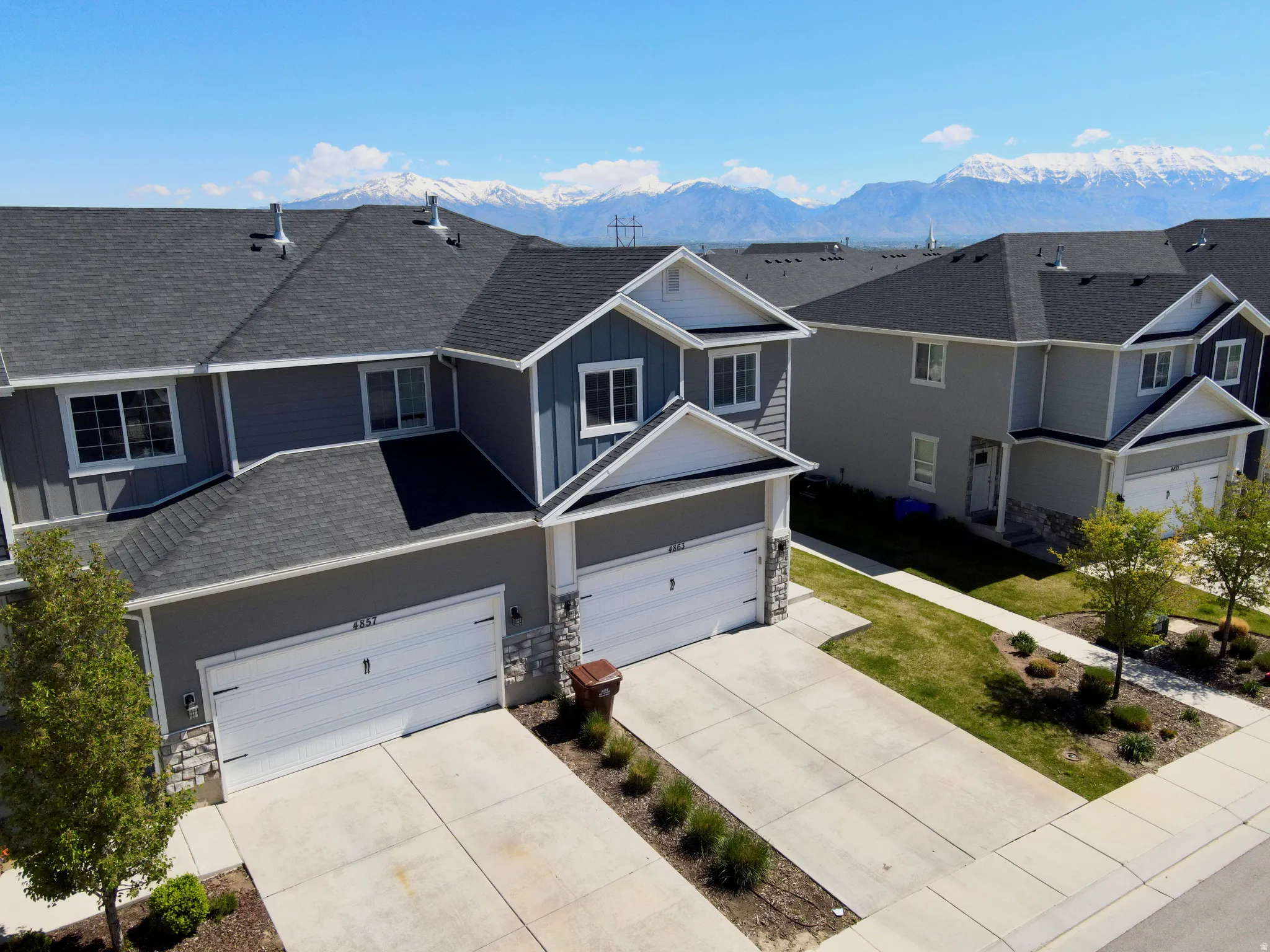 Modern townhome exteriors featuring gray siding and white trim