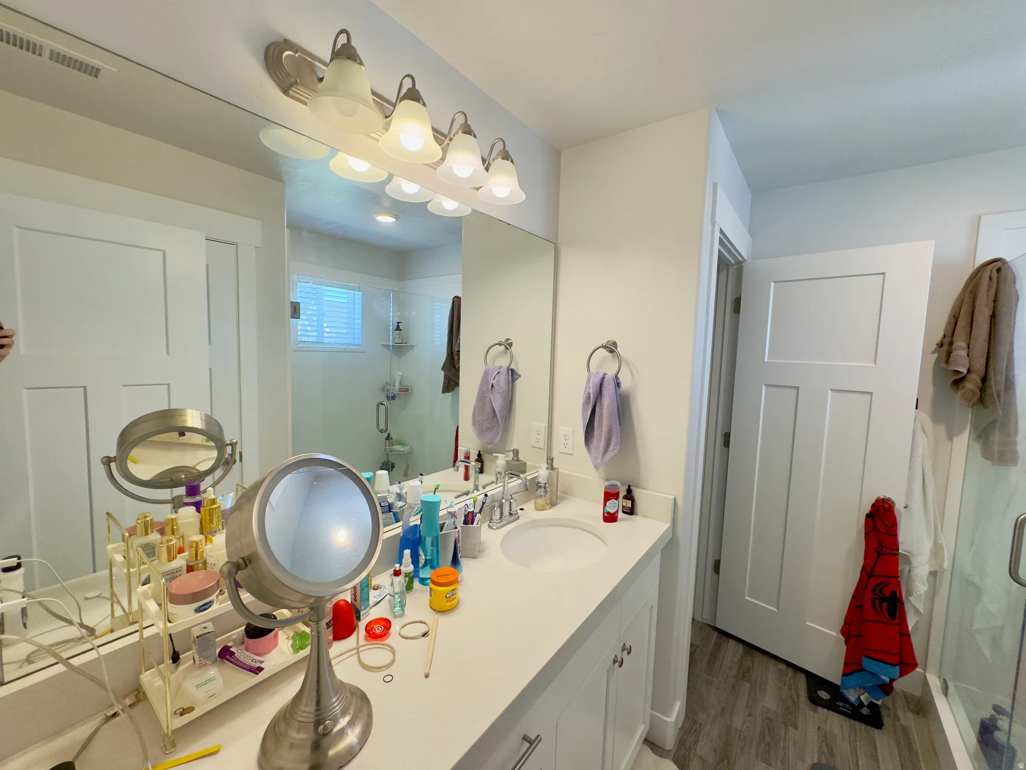 Dual vanity with white cabinetry, a single basin, and light-toned countertop