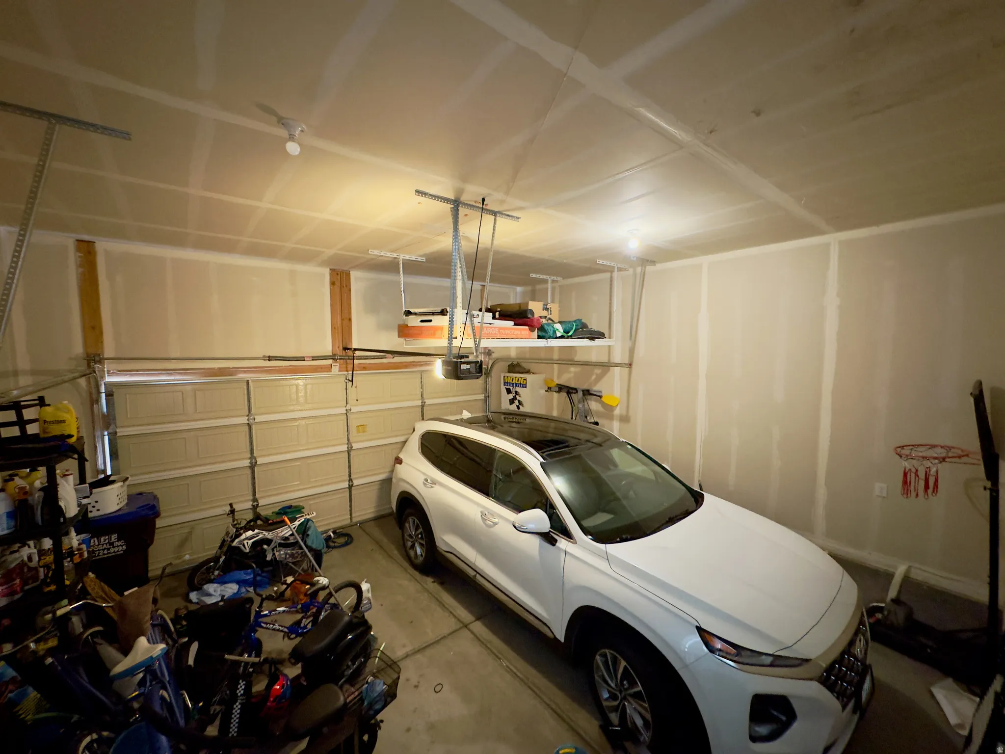 Two-car garage featuring segmented overhead doors and a finished ceiling