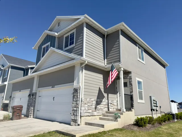 Contemporary two-story residence featuring a multi-textured facade with horizontal siding and stucco elements
