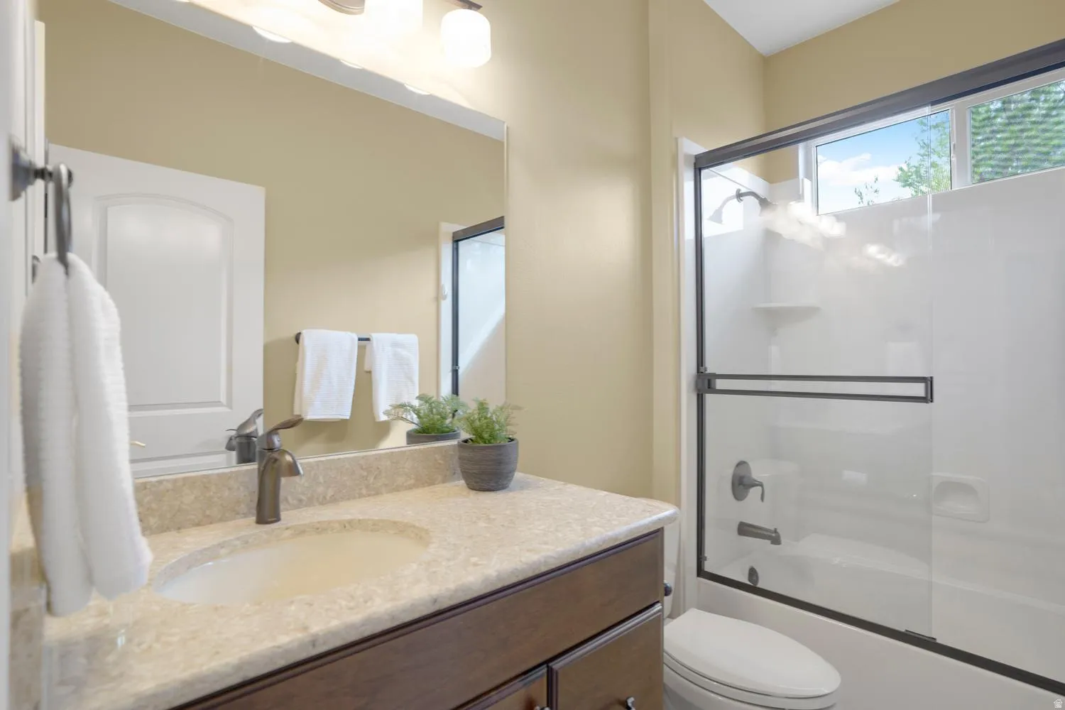 Vanity with an integrated sink and stone-finish countertop