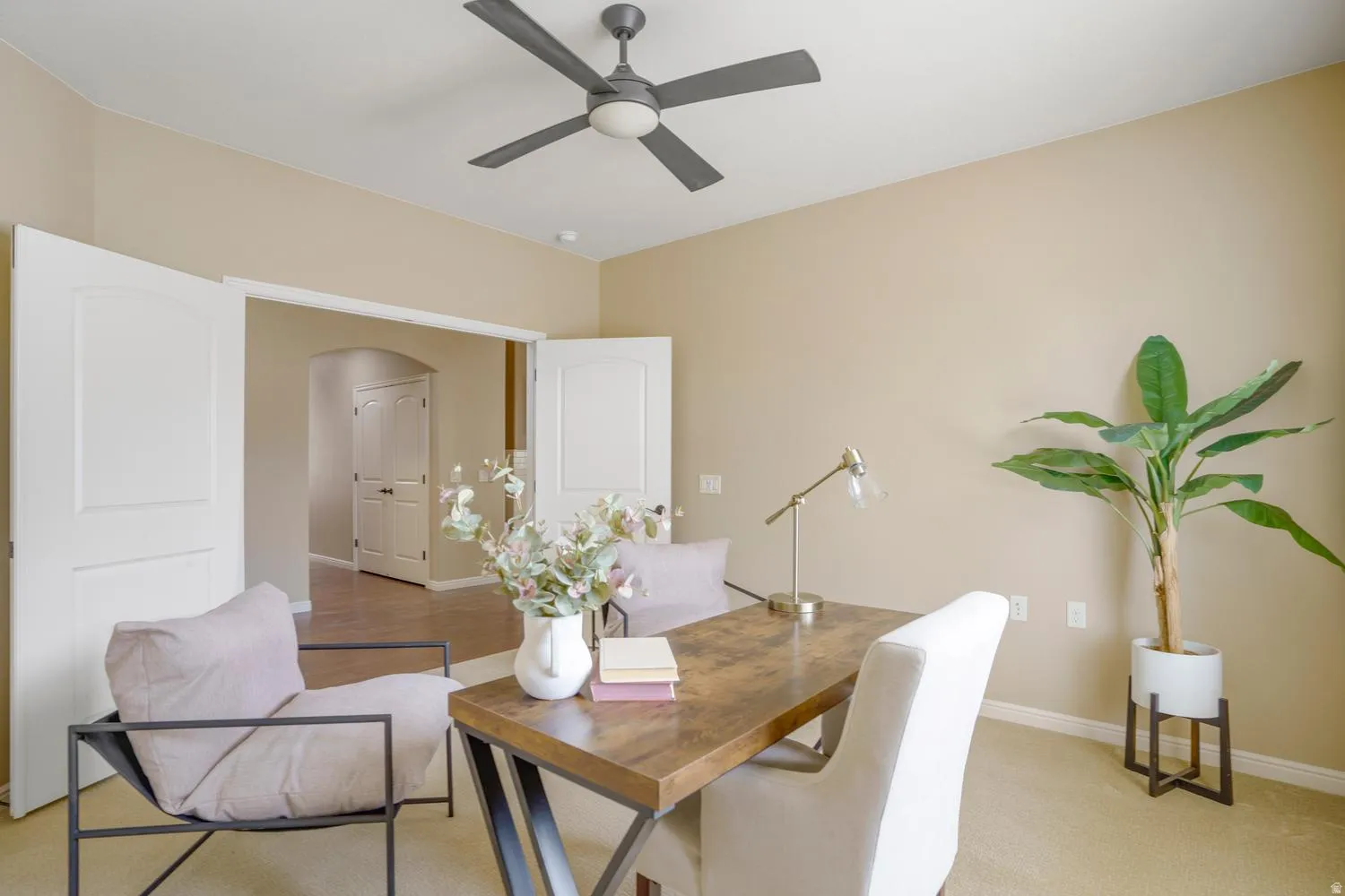 Recessed lighting, ceiling fan, neutral wall tones, and double entry doors