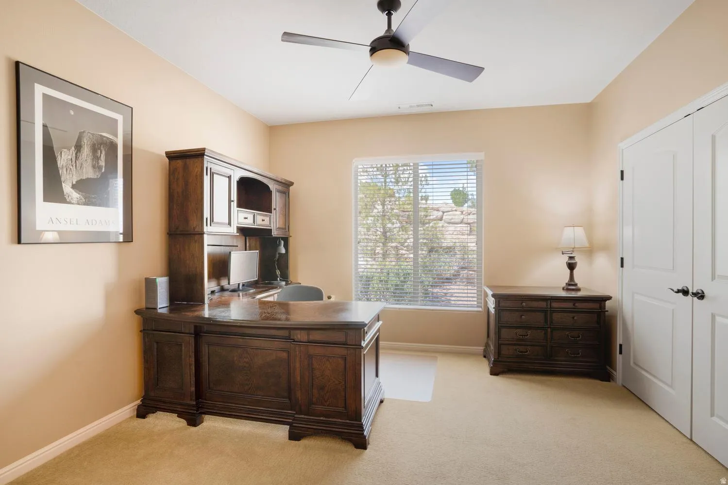 Carpeted room with a ceiling fan, recessed lighting, and a window with horizontal blinds