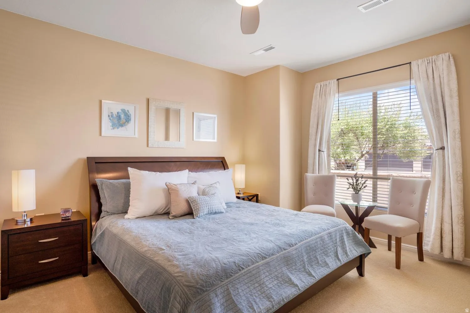 Carpeted bedroom featuring a ceiling fan, window with blinds, and light-toned walls