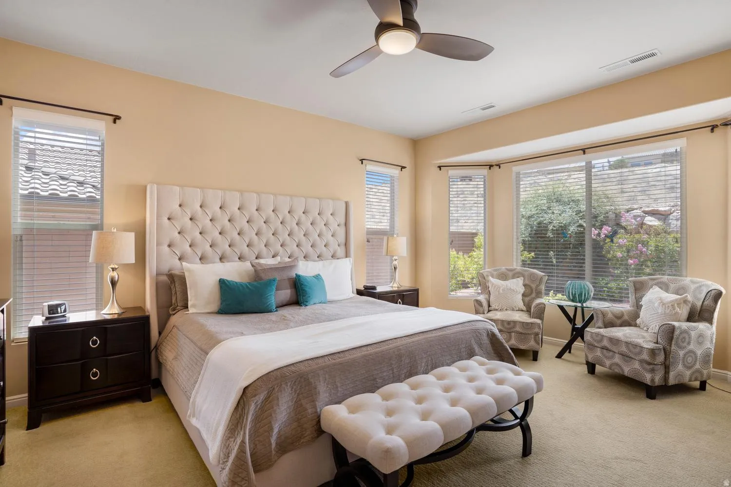 Spacious room featuring a bay window, recessed lighting, and a ceiling fan