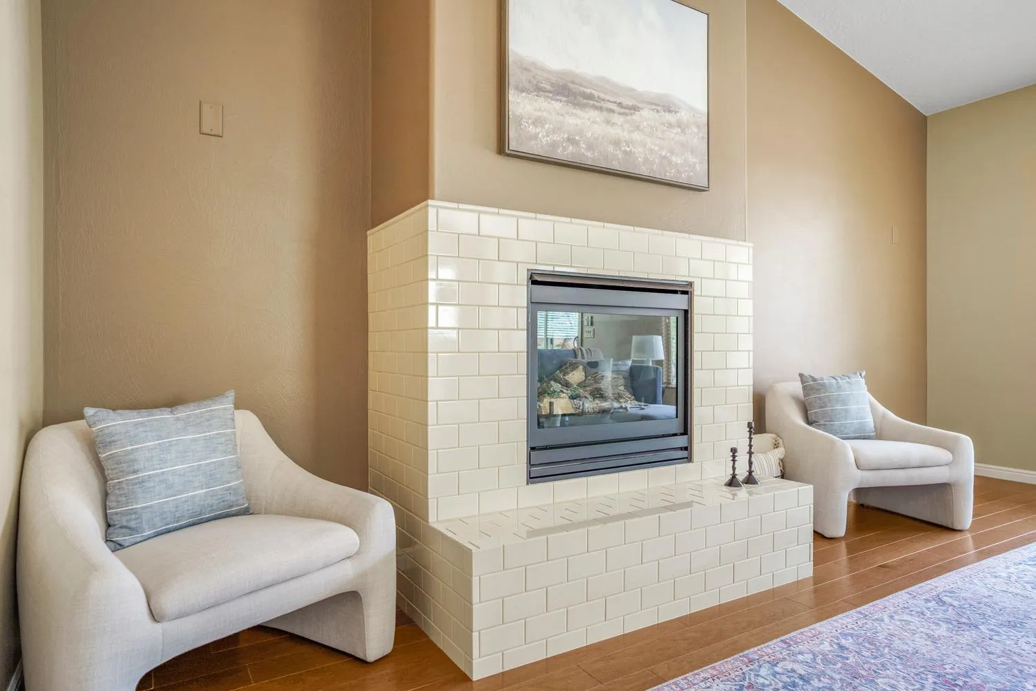 Central fireplace featuring subway tile surround and integrated hearth