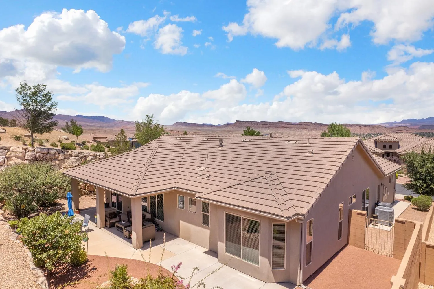 Exterior featuring a tile roof, stucco siding, and a covered patio