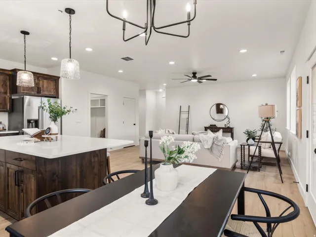 Open-concept living space featuring wood-finish flooring, recessed lighting, and a contemporary ceiling fan